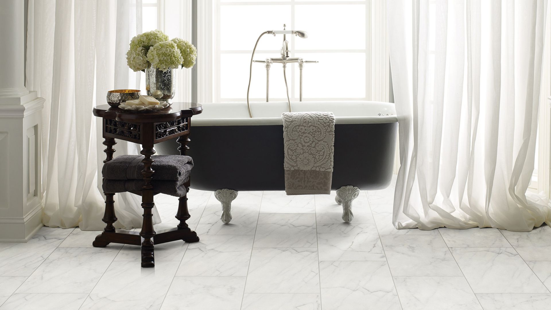 bright white bathroom tile flooring and standalone tub